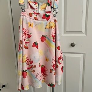 A pink strawberry shortcake overall skirt